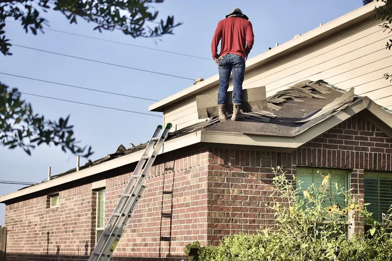 Professional roofer working on a residential roof in Petersburg